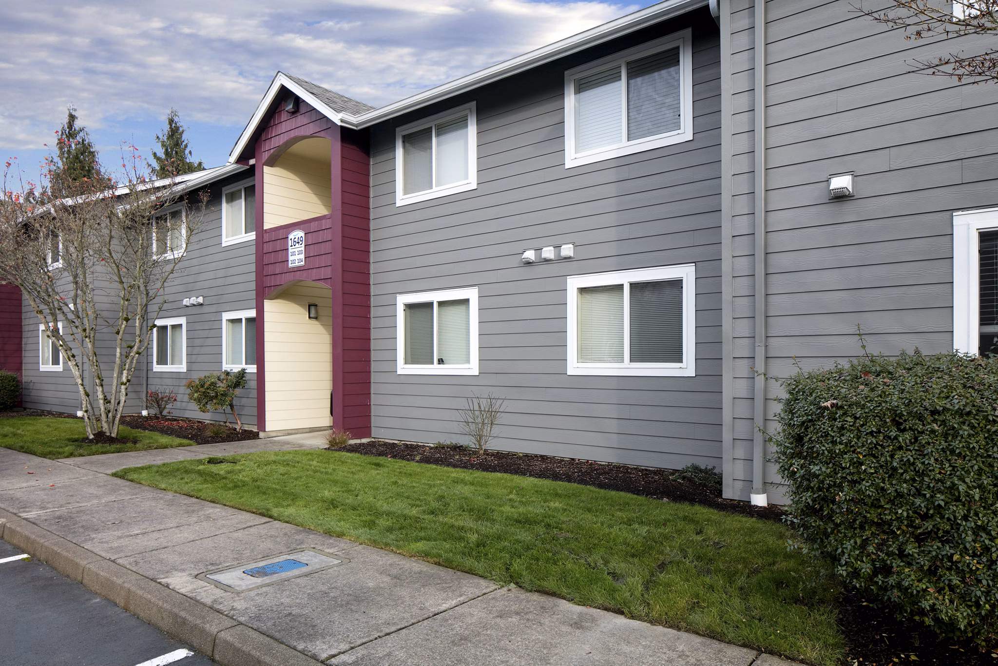Creekside Apartments: Modern view of luxury apartments nestled in a serene wooded area