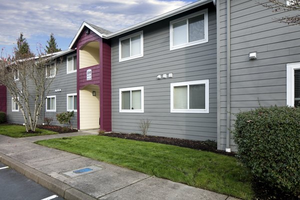 Creekside Apartments: Modern view of luxury apartments nestled in a serene wooded area