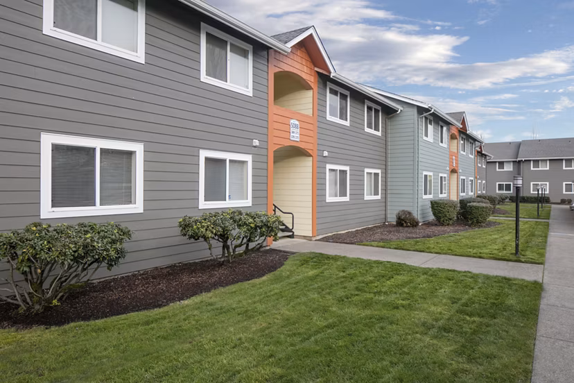 Creekside Apartments: Elegant facade of luxury apartments in serene suburban setting
