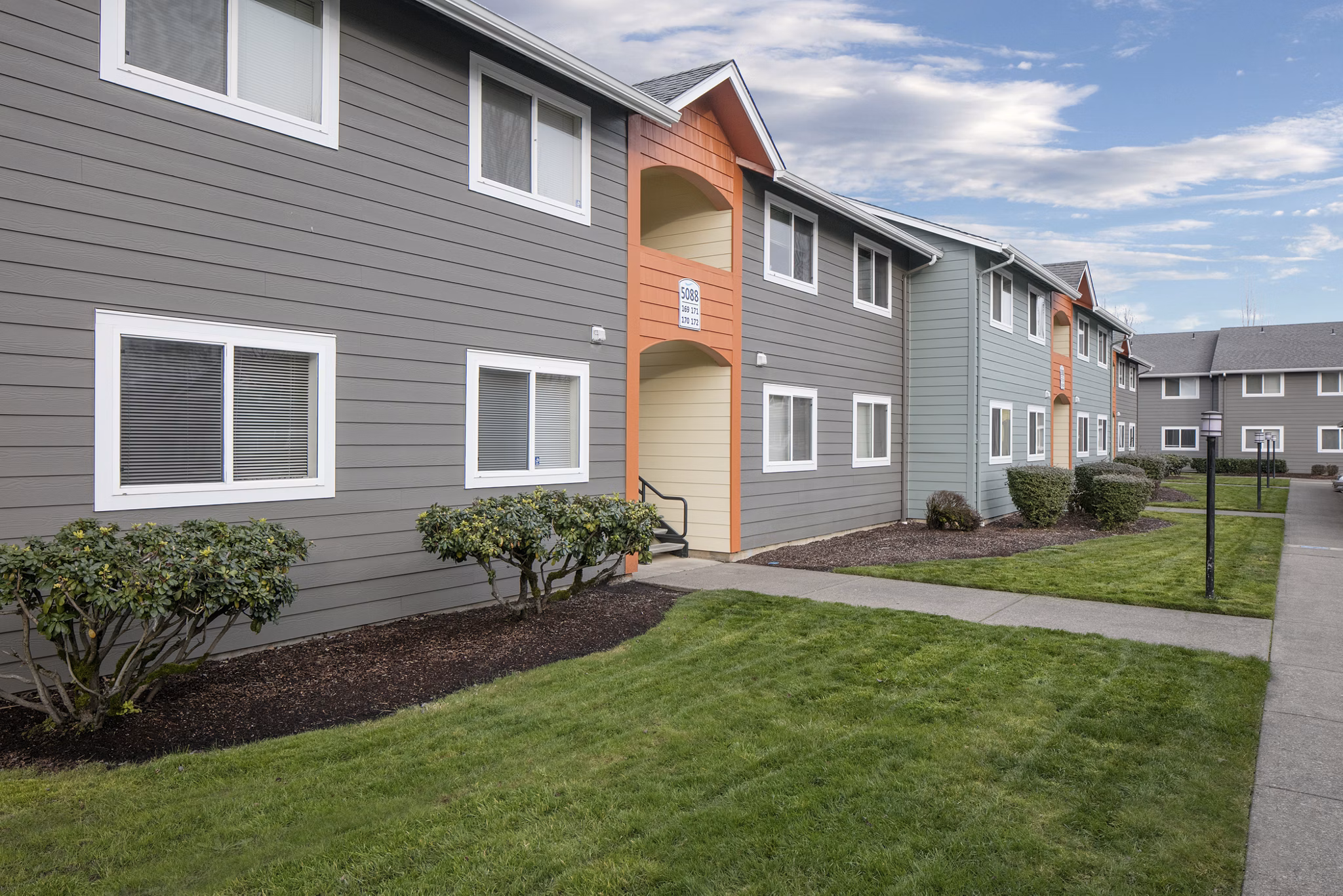 Creekside Apartments: Elegant facade of luxury apartments in serene suburban setting