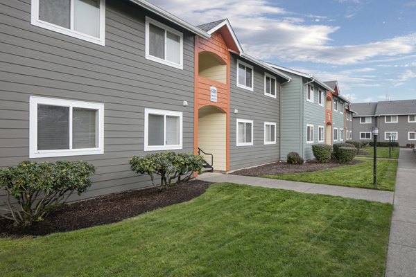 Creekside Apartments: Elegant facade of luxury apartments in serene suburban setting