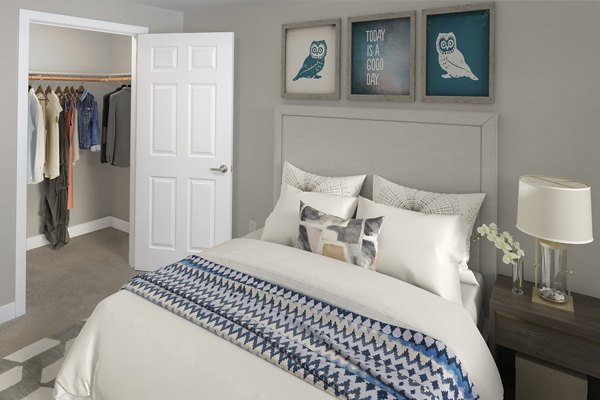 Modern bedroom with cozy decor and ample natural light in Creekside Apartments