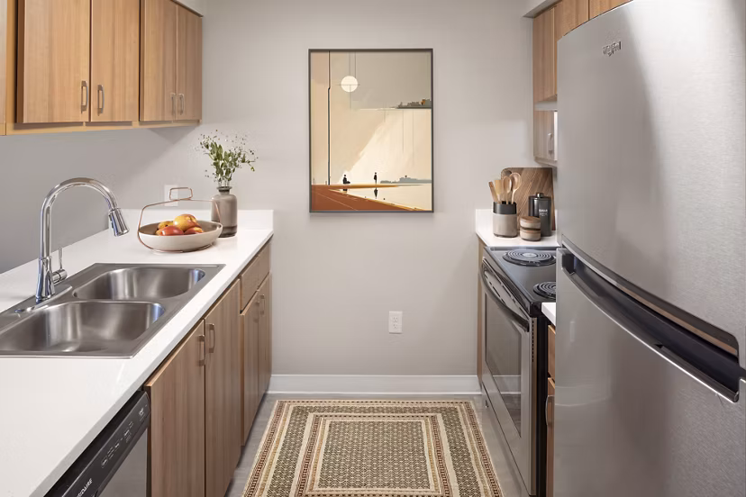 Modern kitchen with stainless steel appliances in Creekside Apartments