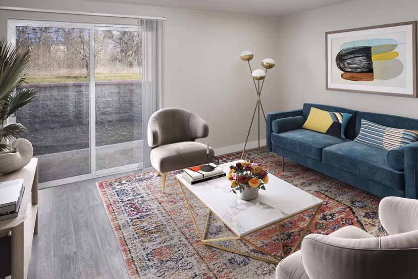 Spacious living room with modern furniture at Creekside Apartments