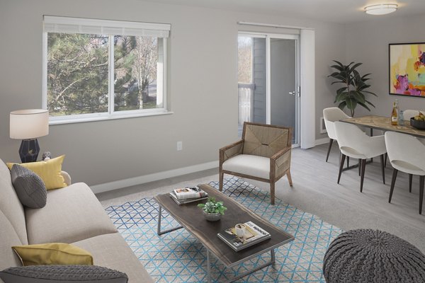 Spacious living room with modern decor and natural light in Creekside Apartments