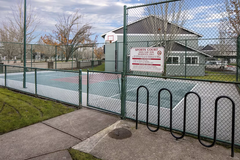 Sport court with basketball hoops at Creekside Apartments