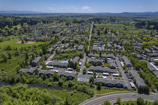 Creekside Apartments: Scenic view of luxury apartments surrounded by lush greenery