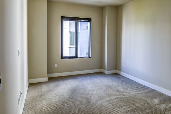 Cozy bedroom with modern decor in Levare Apartments, luxury living by Greystar
