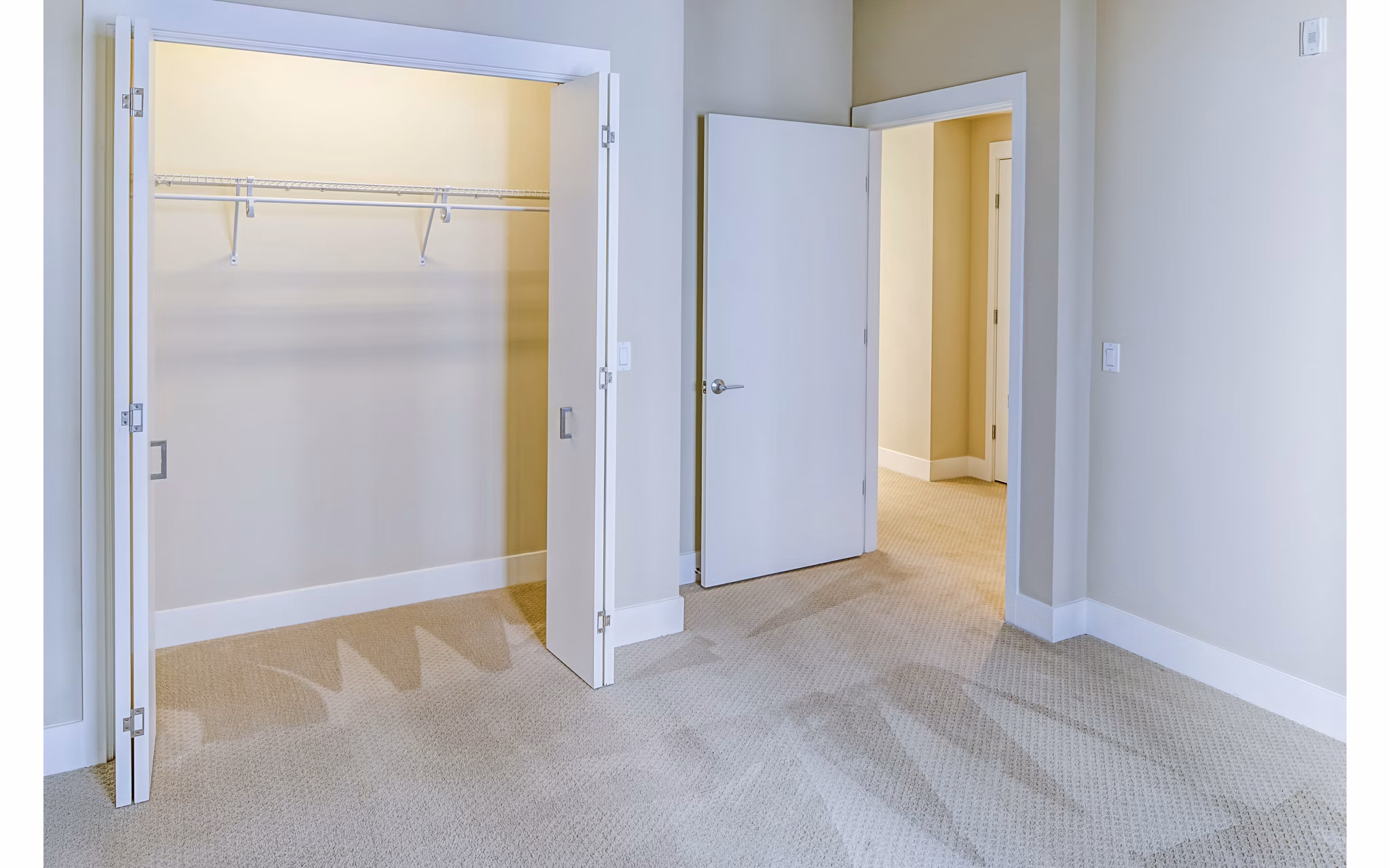 Spacious bedroom featuring modern decor and ample natural light at Levare Apartments in a luxurious setting