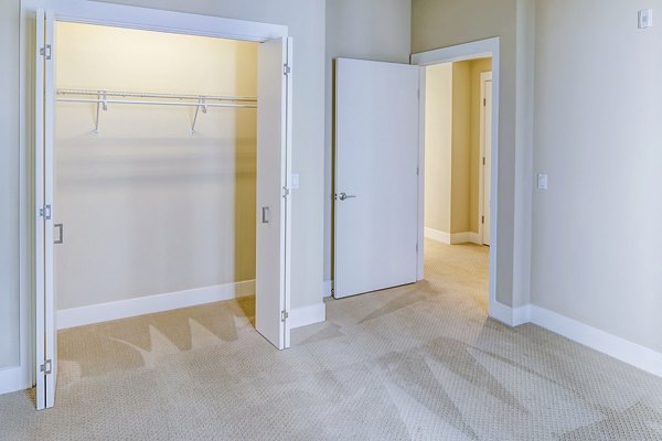 Spacious bedroom featuring modern decor and ample natural light at Levare Apartments in a luxurious setting