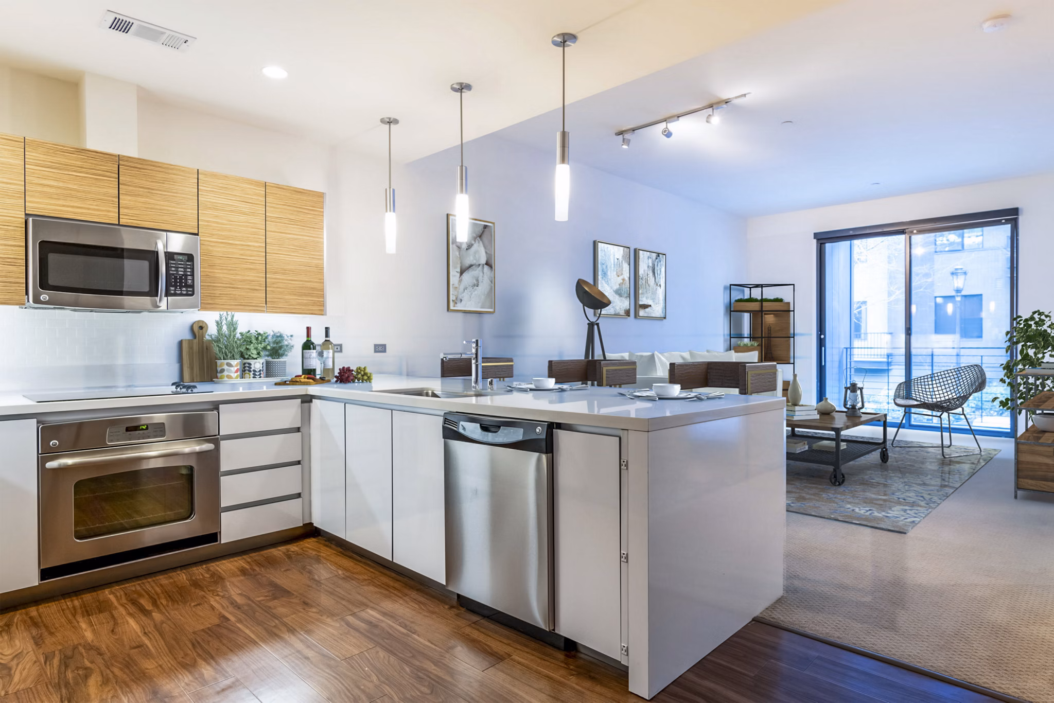Modern kitchen featuring stainless steel appliances and granite countertops at Levare Apartments, luxury living by Greystar
