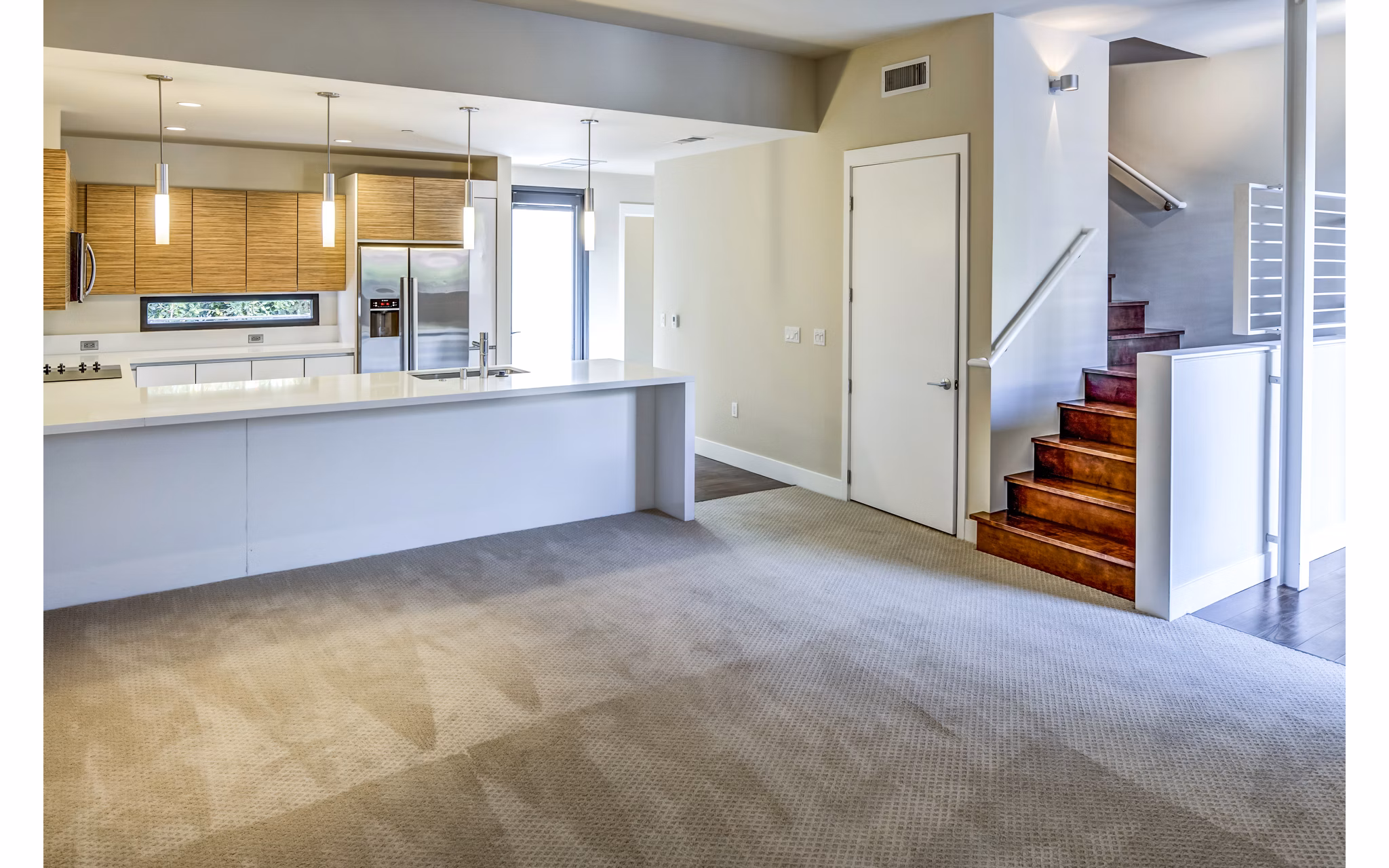 Modern kitchen featuring stainless steel appliances and granite countertops at Levare Apartments