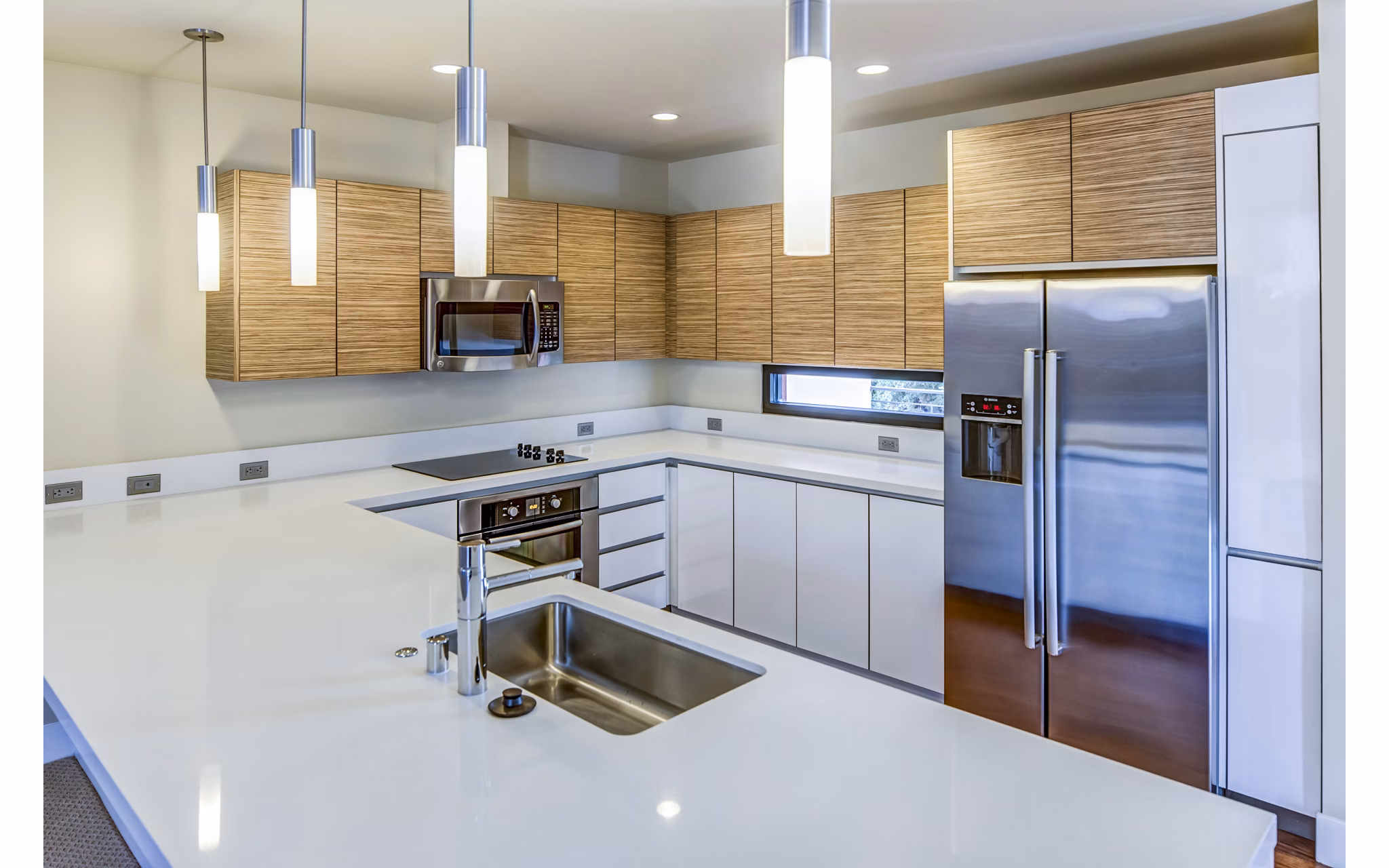 Modern kitchen with sleek countertops and stainless steel appliances at Levare Apartments