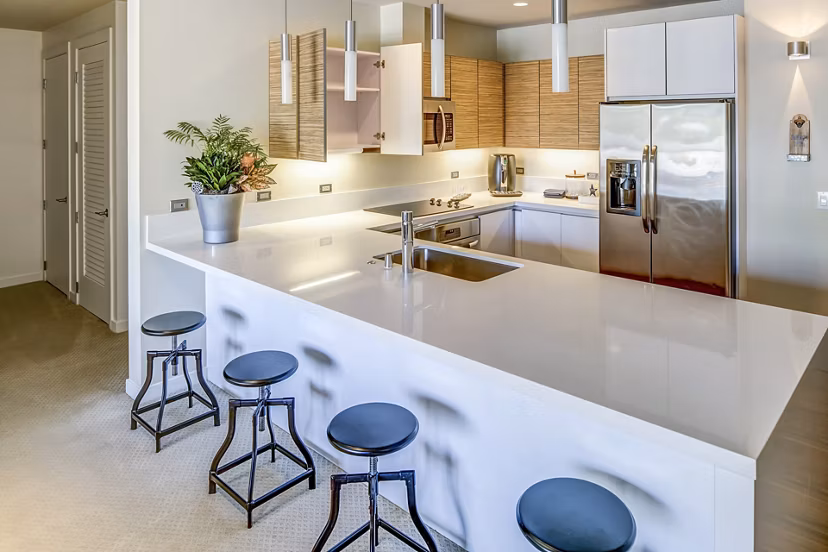 Kitchens with stainless steel appliances and granite countertops in Levare Apartments