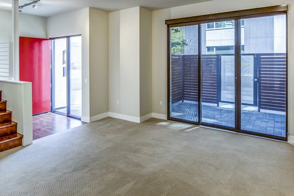 Stylish living room with modern furnishings in Levare Apartments, featuring spacious layout and abundant natural light
