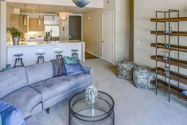 Modern living room with sleek furnishings and natural light at Levare Apartments, upscale rental in vibrant neighborhood