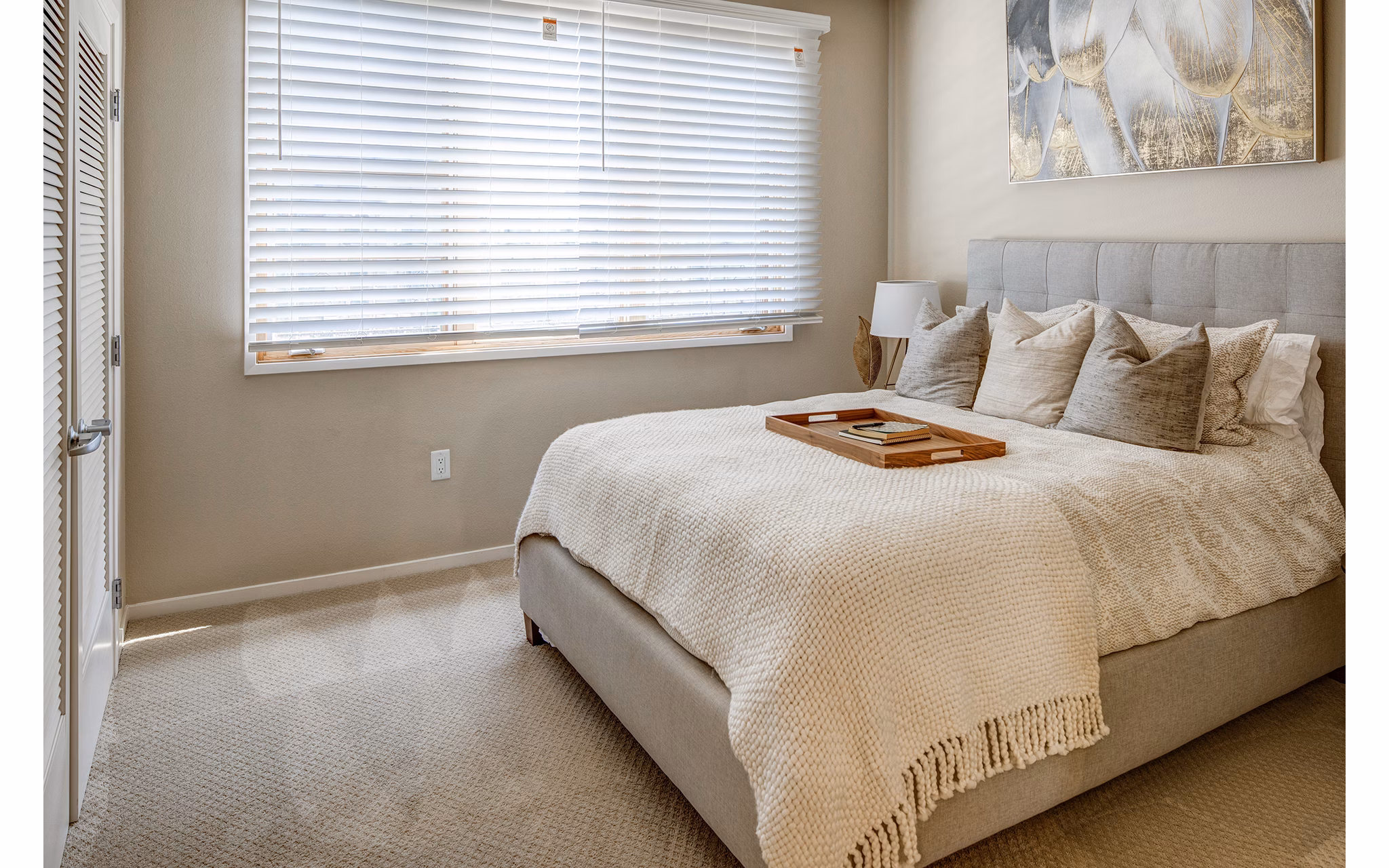 Spacious bedroom with modern decor at Santana Row Apartments in San Jose, featuring large windows and luxury finishes