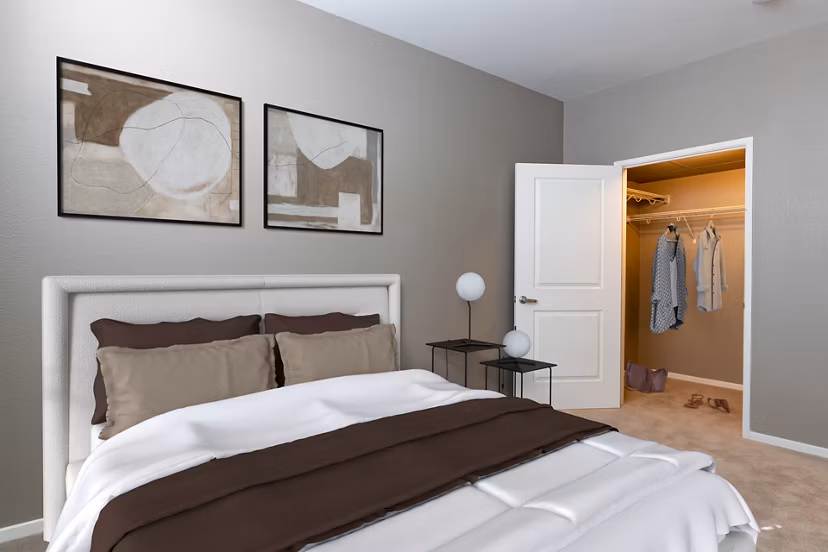 Cozy bedroom with modern decor at Santana Row Apartments, featuring luxury bedding and ample natural light Ideal for Greystar's upscale living experience
