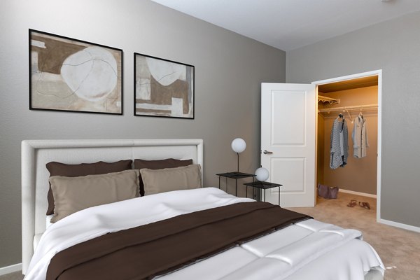 Cozy bedroom with modern decor at Santana Row Apartments, featuring luxury bedding and ample natural light Ideal for Greystar's upscale living experience