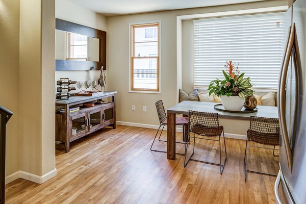 Dining area featuring modern decor and elegant lighting in Santana Row Apartments
