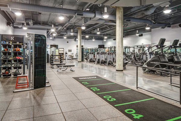 Fully-equipped fitness center featuring modern exercise machines at Santana Row Apartments