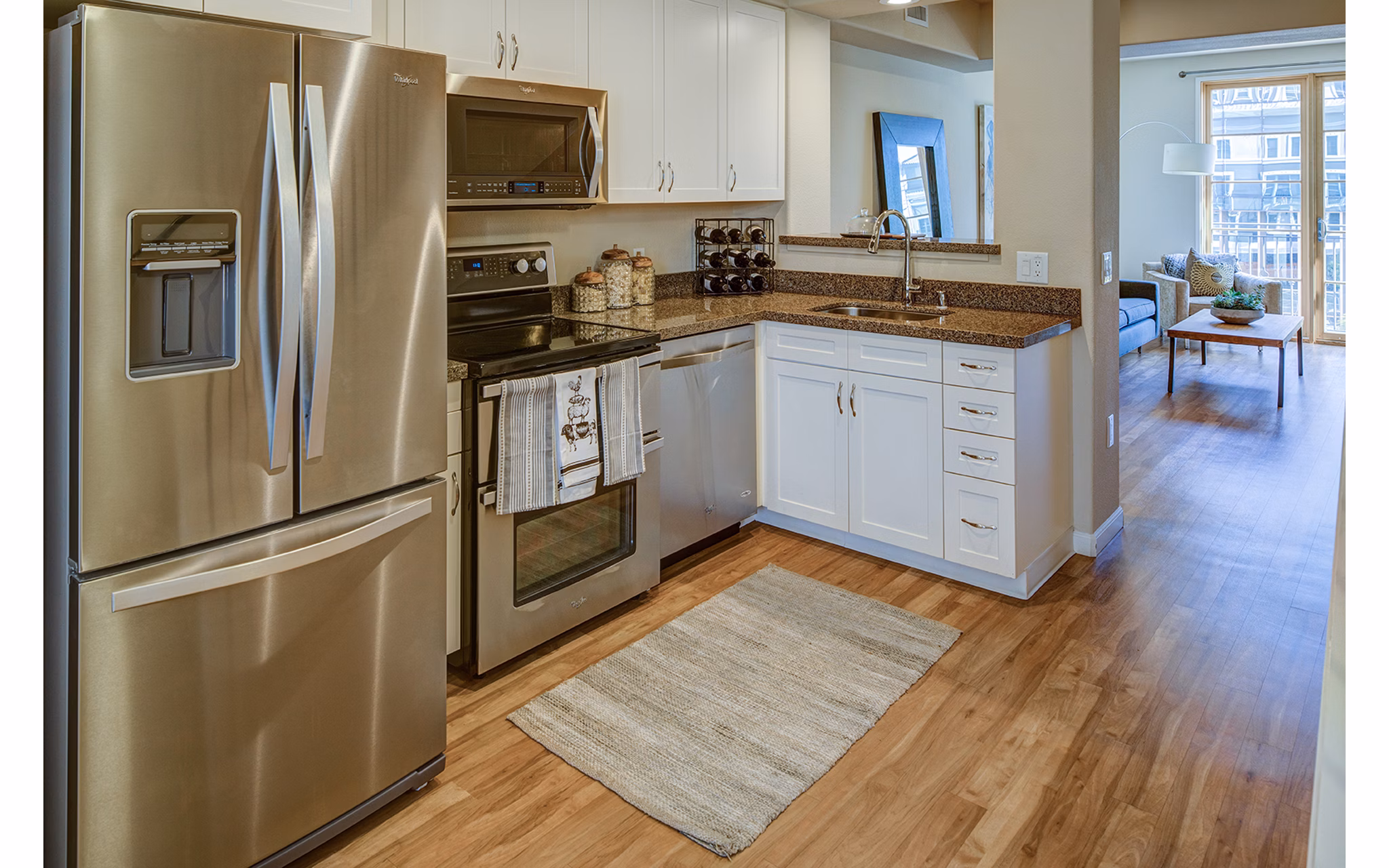 Modern kitchen with stainless steel appliances and island in Santana Row Apartments