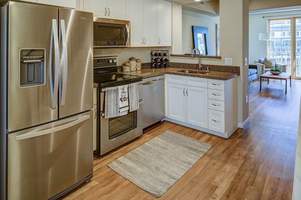 Modern kitchen with stainless steel appliances and island in Santana Row Apartments
