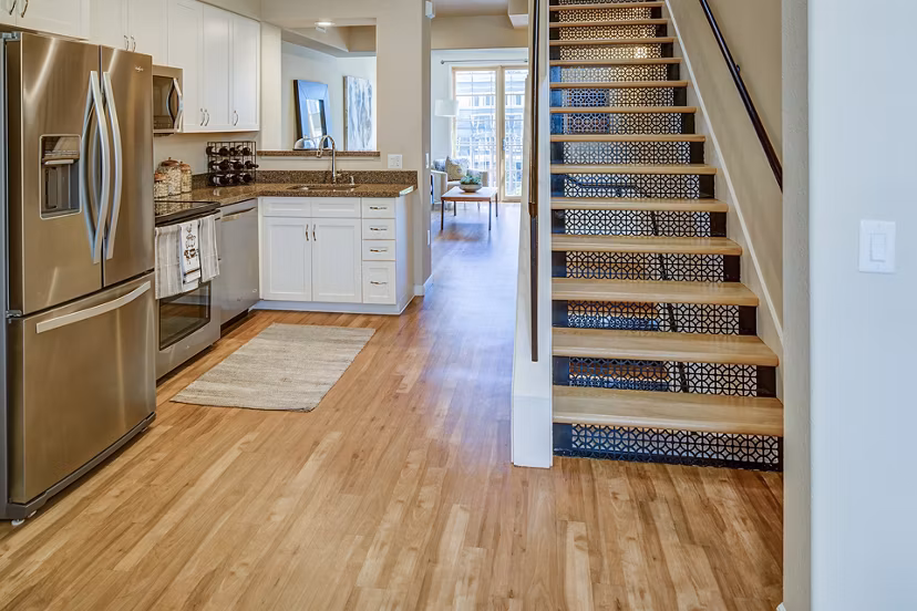 Modern kitchen with stainless steel appliances in Santana Row Apartments