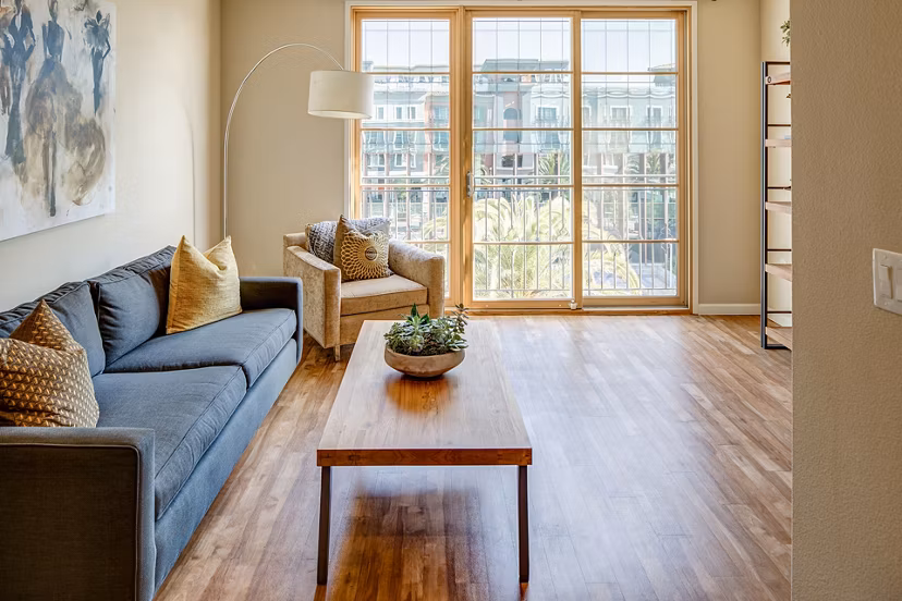 Inviting living room with modern decor and large windows at Santana Row Apartments