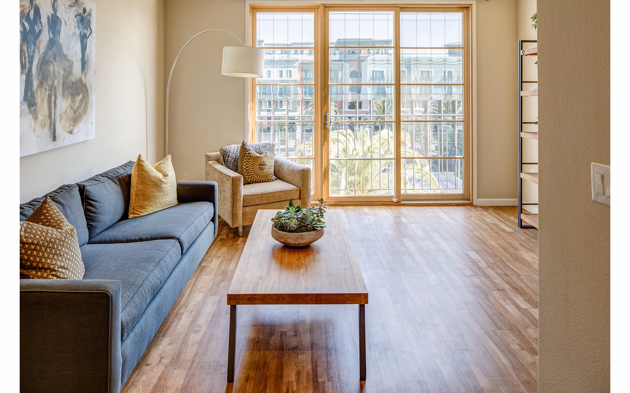Inviting living room with modern decor and large windows at Santana Row Apartments