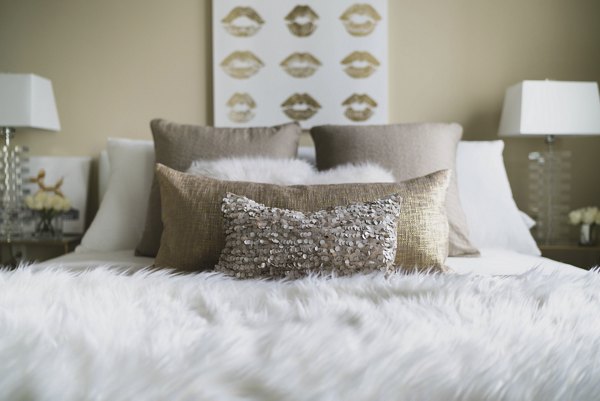 Bright bedroom with modern furnishings at Wilshire Vermont Station Apartments offering luxury living in an urban setting