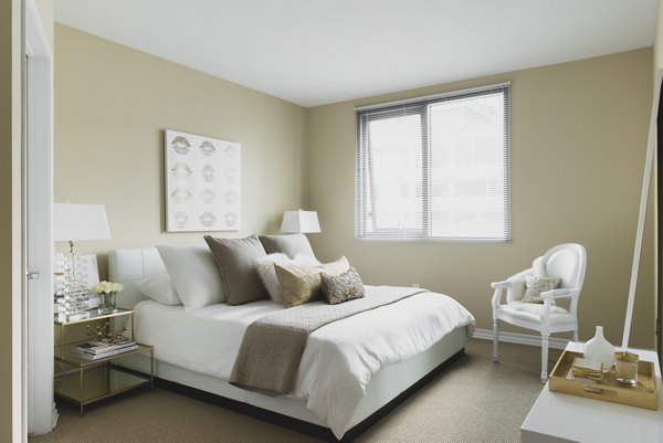 Cozy bedroom with modern decor at Wilshire Vermont Station Apartments in Los Angeles