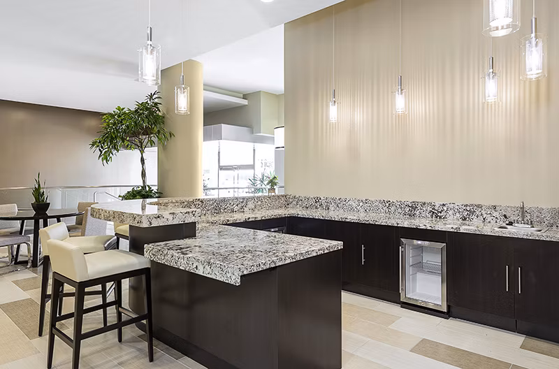 Clubhouse with modern furnishings and vibrant decor at Wilshire Vermont Station Apartments