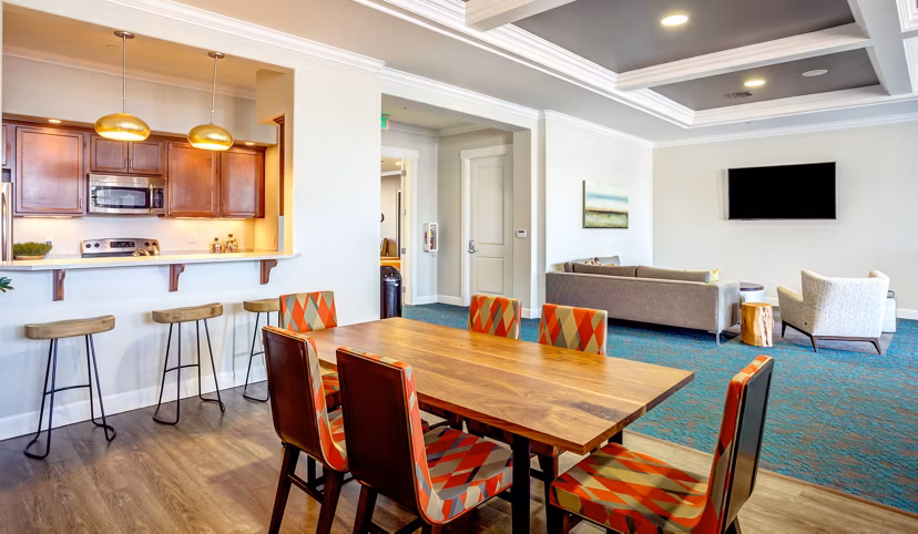 Elegant clubhouse with modern seating and large windows at Apex Apartments, ideal for luxury living and community gatherings