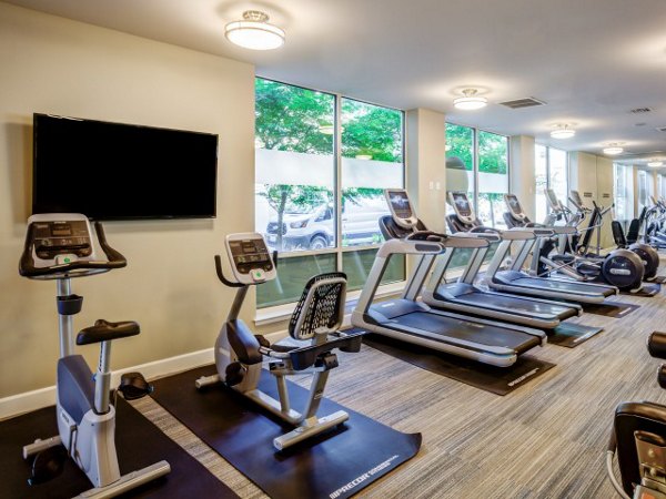Modern fitness center with state-of-the-art equipment at Apex Apartments, offering a premium workout experience for residents