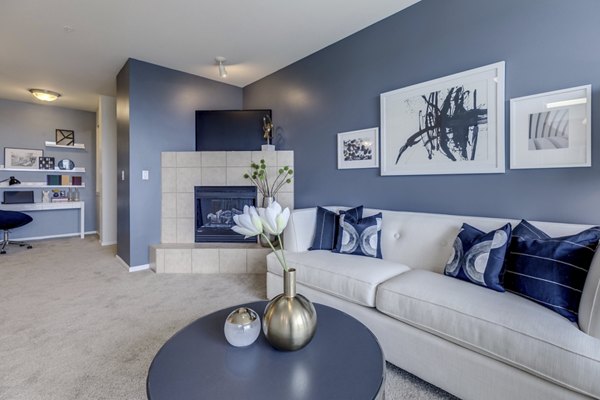 Modern living room with sleek furniture at Apex Apartments offering luxury living amenities