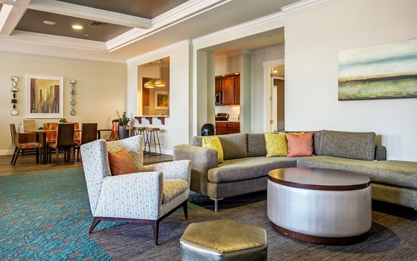 Living room with modern decor and natural light at Apex Apartments