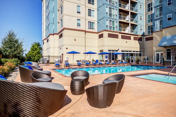 Modern outdoor pool with sun deck at Apex Apartments, offering luxury amenities in a vibrant community atmosphere