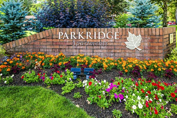 Parkridge Apartments sign with landscaped flowers and greenery in front of luxury apartment property