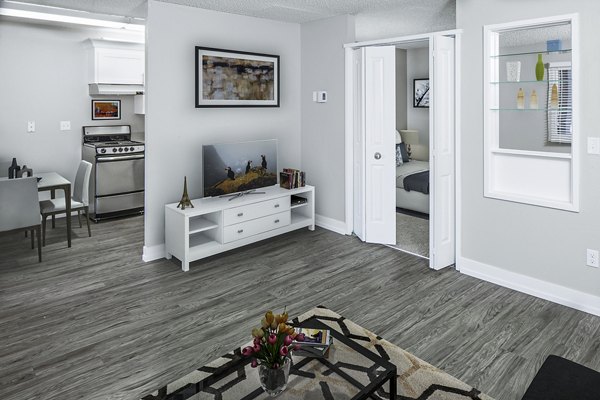 Living room featuring modern furniture and open layout in Parkridge Apartments, offering a welcoming space for relaxation and entertainment