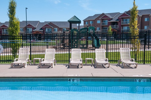 Outdoor pool with lush landscaping at The Homestead Apartments, a luxury living option by Greystar