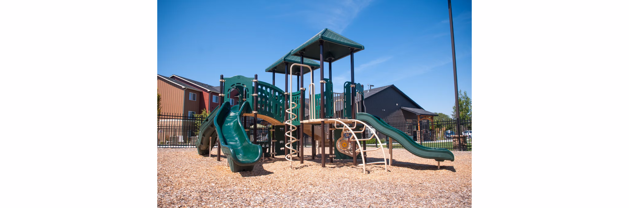 Colorful children's playground at The Homestead Apartments offering an engaging recreational area for families and residents
