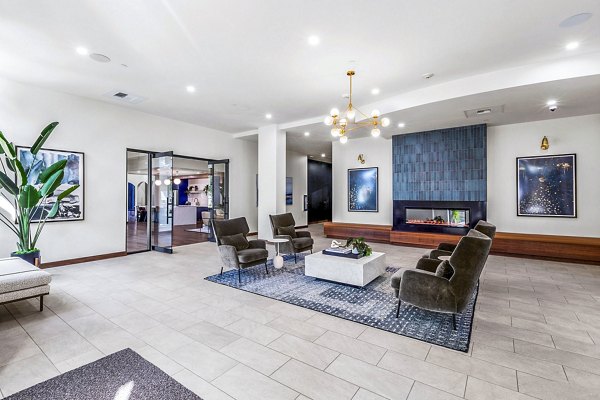 Clubhouse game room with pool table and TV lounge at The Bristol at Southport Apartments