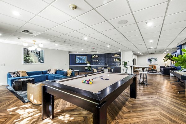 Clubhouse game room at The Bristol at Southport Apartments featuring pool table and comfortable seating for residents to enjoy leisure activities