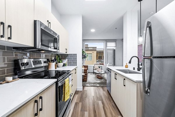 Modern kitchen with stainless steel appliances at The Bristol at Southport Apartments