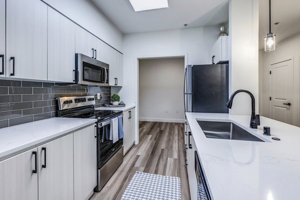 Modern kitchen with stainless steel appliances in The Bristol at Southport Apartments