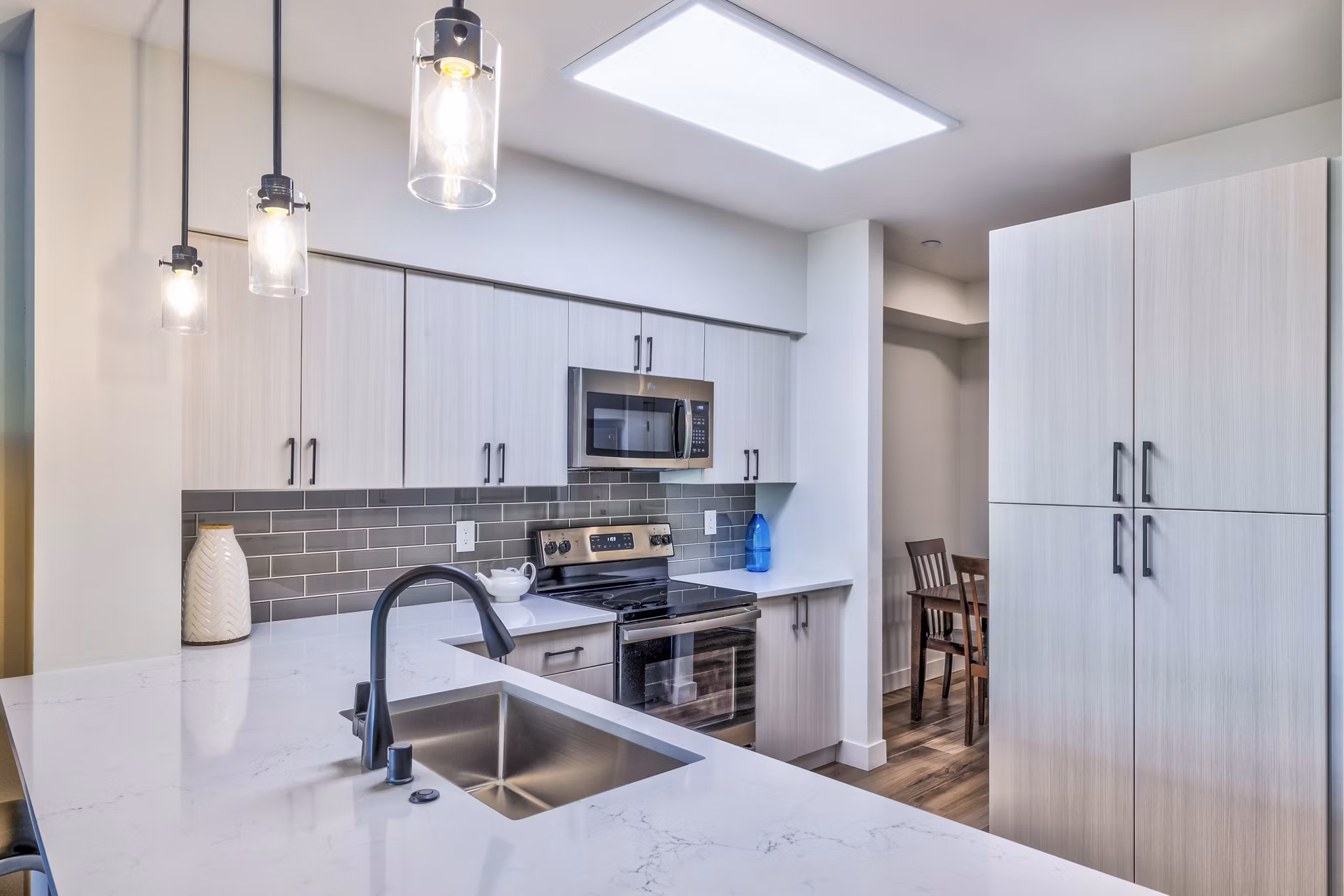 Modern kitchen with stainless steel appliances in The Bristol at Southport Apartments