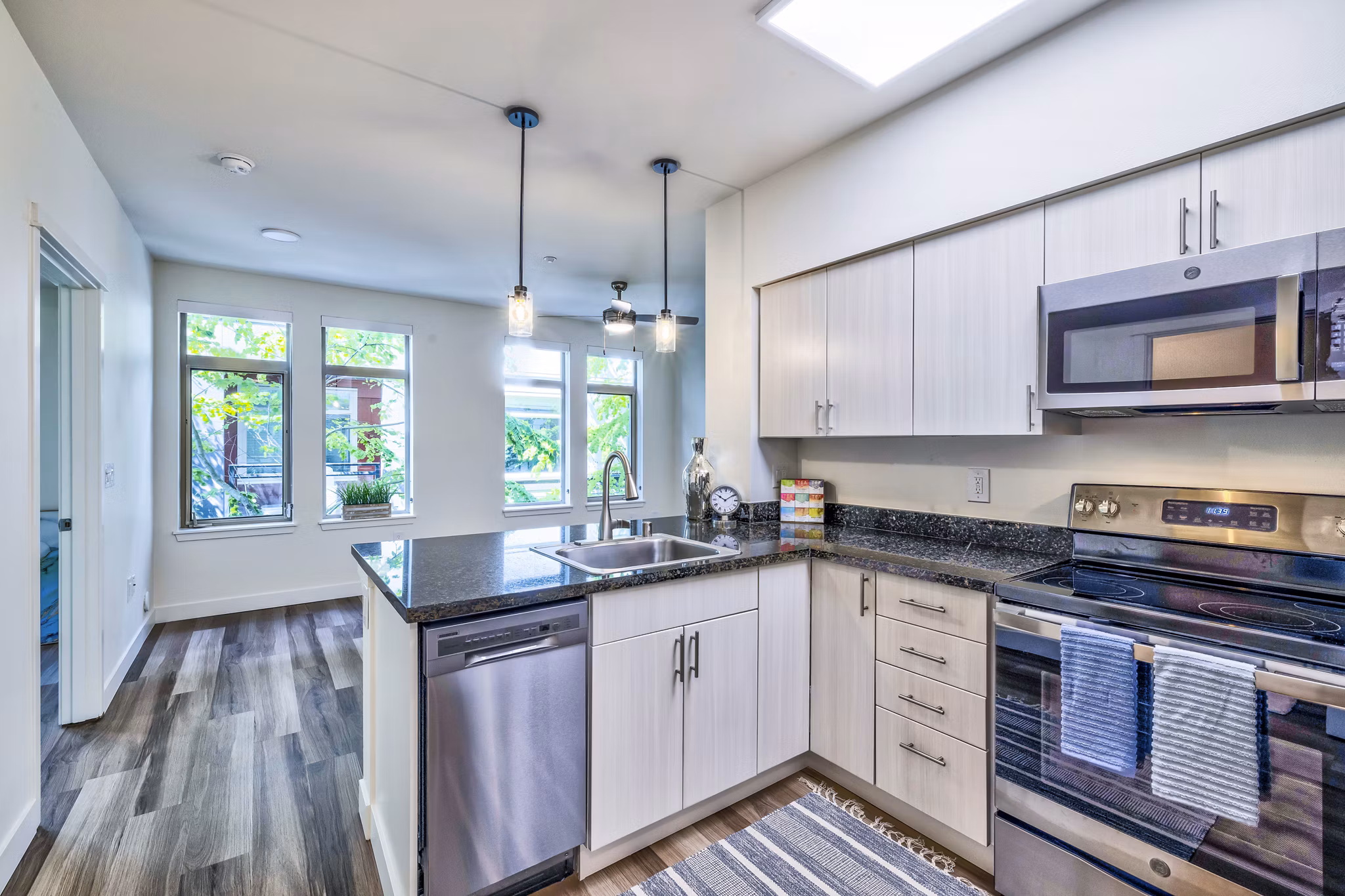 Kitchens with sleek countertops and stainless steel appliances at The Bristol at Southport Apartments