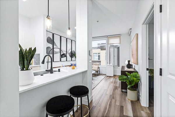 Spacious kitchen with modern appliances and granite countertops in The Bristol at Southport Apartments