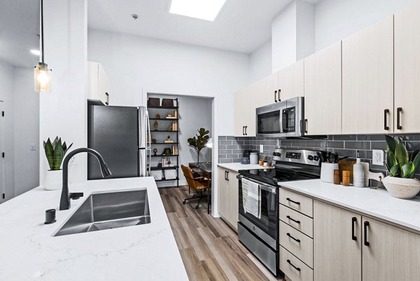 Modern kitchen with stainless steel appliances at The Bristol at Southport Apartments